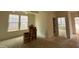 Bright living room featuring a trey ceiling, neutral walls, and ample natural light from the large window at 776 Old Station Pointe, Angier, NC 27501