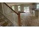 Open-concept living area with stairs, multiple windows, and sliding glass doors leading to outdoor space at 776 Old Station Pointe, Angier, NC 27501
