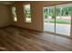 Open living room with wood-look flooring and access to the back patio through sliding glass doors at 776 Old Station Pointe, Angier, NC 27501