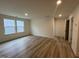 Living room with wood-look floors, natural light and neutral paint at 776 Old Station Pointe, Angier, NC 27501