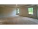 Unfinished main bedroom featuring two windows providing natural light at 776 Old Station Pointe, Angier, NC 27501