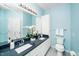 Bright bathroom featuring double sinks and blue walls at 8231 Allyns Landing Way # 302, Raleigh, NC 27615
