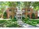 Brick condo building exterior with mature trees and manicured landscaping at 8231 Allyns Landing Way # 302, Raleigh, NC 27615