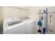 Well-lit laundry room with washer, dryer, and shelving at 8231 Allyns Landing Way # 302, Raleigh, NC 27615