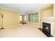 Living room with fireplace, crown molding, large windows, and tan walls and carpet at 8231 Allyns Landing Way # 302, Raleigh, NC 27615