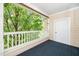 A cozy covered patio with a white railing offers an ideal spot for outdoor relaxation and entertaining at 8231 Allyns Landing Way # 302, Raleigh, NC 27615