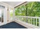A covered patio with white railings allows for private relaxation space with views of the surrounding landscape at 8231 Allyns Landing Way # 302, Raleigh, NC 27615