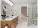 Bathroom featuring double vanity, updated counters, with an updated glass shower at 8814 Waynick Dr, Raleigh, NC 27617