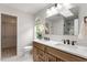 Bathroom featuring double vanity, updated counters, and a closet at 8814 Waynick Dr, Raleigh, NC 27617