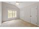 Bright bedroom featuring a window, closet, ceiling fan, and neutral carpet at 8814 Waynick Dr, Raleigh, NC 27617