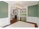 Dining room showcasing an elegant light fixture, archways, and hardwood floors that flow into the living room at 8814 Waynick Dr, Raleigh, NC 27617
