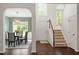 Foyer featuring hardwood floors, staircase, an elegant light fixture, and views of the dining room at 8814 Waynick Dr, Raleigh, NC 27617