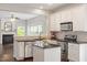 Updated kitchen with white cabinets, granite countertops, stainless steel appliances, and a peninsula at 8814 Waynick Dr, Raleigh, NC 27617