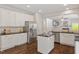 Modern kitchen featuring stainless appliances, white cabinetry, granite countertops, and central island at 8814 Waynick Dr, Raleigh, NC 27617