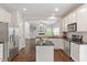Bright kitchen with stainless steel appliances, granite countertops, and island, open to living area at 8814 Waynick Dr, Raleigh, NC 27617