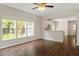 Open-concept living room with hardwood floors, and bright windows leading to the kitchen at 8814 Waynick Dr, Raleigh, NC 27617