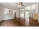Open-concept living area with hardwood floors connecting to the kitchen and dining areas, plus a staircase at 8814 Waynick Dr, Raleigh, NC 27617