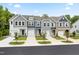 Charming townhome exteriors featuring varied colors and attached garages for convenient living in a vibrant community at 908 Kensley Grove Lane St #69, Fuquay Varina, NC 27526