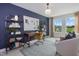 Stylish home office featuring a desk, shelving, plush chair, and natural light from large windows at 908 Kensley Grove Lane St #69, Fuquay Varina, NC 27526