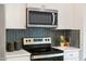 Bright kitchen features stainless steel appliances, subway tile backsplash, and white countertops at 908 Kensley Grove Lane St #69, Fuquay Varina, NC 27526