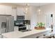 Modern kitchen featuring white cabinets, stainless steel appliances, large island with seating, and stylish pendant lights at 908 Kensley Grove Lane St #69, Fuquay Varina, NC 27526
