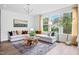 Bright living room with large windows, hardwood floors, and modern decor at 908 Kensley Grove Lane St #69, Fuquay Varina, NC 27526