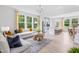 Open-concept living room features lots of natural light, an island, and hardwood floors at 908 Kensley Grove Lane St #69, Fuquay Varina, NC 27526