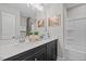 Well-lit bathroom featuring double sinks, framed art, and a shower-tub combination at 908 Kensley Grove Ln # 69, Fuquay Varina, NC 27526