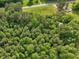An aerial view of land featuring a house, a road, and a forest at 9652 S Nc-87 Hwy, Graham, NC 27253