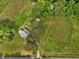 Expansive property showcasing an home, sheds, mature trees and greenery from an aerial perspective at 9652 S Nc-87 Hwy, Graham, NC 27253