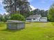 Expansive backyard featuring a lush green lawn and a small block outbuilding at 9652 S Nc-87 Hwy, Graham, NC 27253