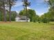 Expansive backyard featuring a lush green lawn and mature trees at 9652 S Nc-87 Hwy, Graham, NC 27253
