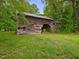 Charming wooden barn with open doorway, surrounded by verdant grass at 9652 S Nc-87 Hwy, Graham, NC 27253