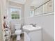 Cozy bathroom featuring white fixtures, a sink vanity, toilet, and a shower with curtain at 9652 S Nc-87 Hwy, Graham, NC 27253