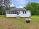 View of single-story home with a screened porch and lush green lawn at 9652 S Nc-87 Hwy, Graham, NC 27253