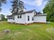 Side view of single-story home with a screened porch and lush green lawn at 9652 S Nc-87 Hwy, Graham, NC 27253