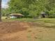 Picturesque acreage with an open shed, old building and mature trees providing natural shade and privacy at 9652 S Nc-87 Hwy, Graham, NC 27253