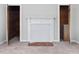 Living room featuring neutral carpeting and a decorative fireplace with built-in storage behind the door at 9652 S Nc-87 Hwy, Graham, NC 27253