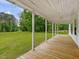 Inviting covered front porch featuring a wood deck with scenic views at 9652 S Nc-87 Hwy, Graham, NC 27253