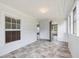Sunroom features windows, white wood walls, and tile flooring at 9652 S Nc-87 Hwy, Graham, NC 27253