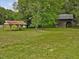 Expansive front yard view encompassing the home, open shelter, and a vintage wooden barn at 9652 S Nc-87 Hwy, Graham, NC 27253