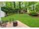 Large landscaped backyard with patio and playground set at 1008 Winona Rd, Raleigh, NC 27609