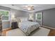 Bedroom boasts soft, neutral colors, two windows, and a ceiling fan at 1008 Winona Rd, Raleigh, NC 27609