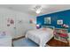 Bright bedroom features a white ceiling fan, white bedding, and a blue accent wall at 1008 Winona Rd, Raleigh, NC 27609