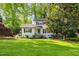 Charming two-story home with landscaped yard, blue door, black shutters, and a manicured lawn on a sunny day at 1008 Winona Rd, Raleigh, NC 27609