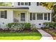 Charming home featuring a walkway, manicured lawn, landscaping, and a welcoming entrance with a blue door at 1008 Winona Rd, Raleigh, NC 27609