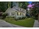 Well-maintained two-story home with green lawn, mature trees, and lovely landscaping at 1008 Winona Rd, Raleigh, NC 27609