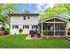 Rear exterior features brick patio, grilling area, screened porch and lush lawn at 1008 Winona Rd, Raleigh, NC 27609