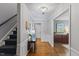 Elegant foyer with hardwood floors, staircase with patterned carpet, decorative lighting, and stylish accents at 1008 Winona Rd, Raleigh, NC 27609