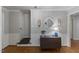 Bright foyer with hardwood floors, decorative lighting, and a staircase with patterned carpet at 1008 Winona Rd, Raleigh, NC 27609